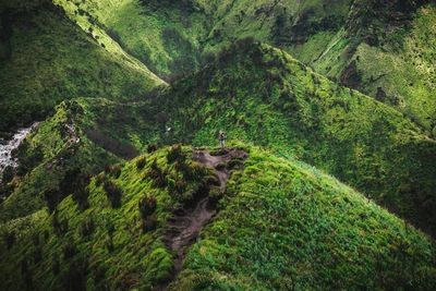 High angle view of man standing on scenic mountains