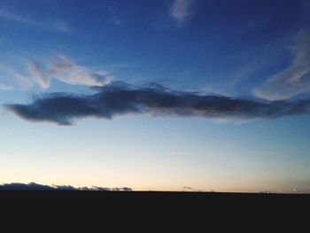 Scenic view of landscape against cloudy sky