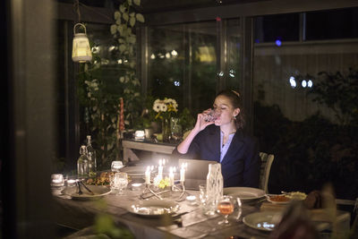 Woman at table using digital tablet