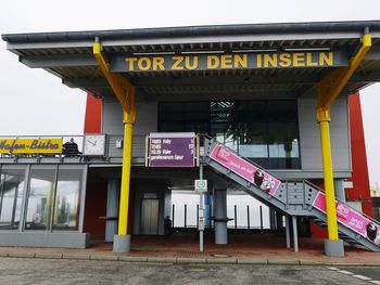 Entrance of building against sky in city