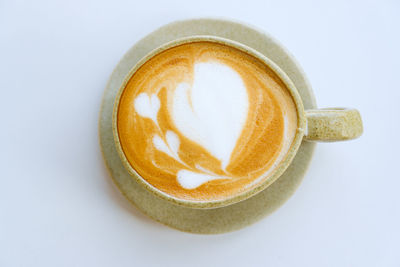 Close-up of coffee cup over white background