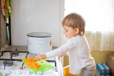 Portrait of cute girl preparing food at home