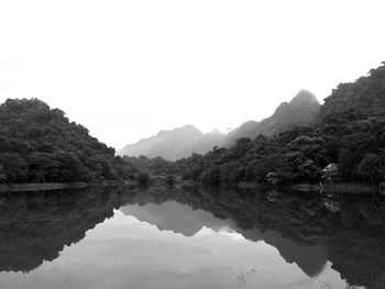 Scenic view of lake and mountains against clear sky