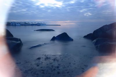 Scenic view of sea against cloudy sky