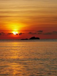 Scenic view of sea against romantic sky at sunset