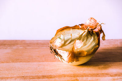 Close-up of apple on table against white background