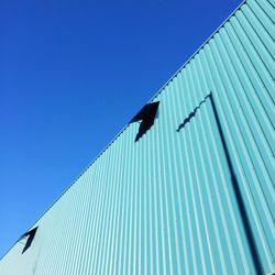 Low angle view of building against blue sky