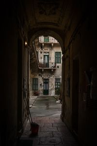 Empty alley amidst buildings in city