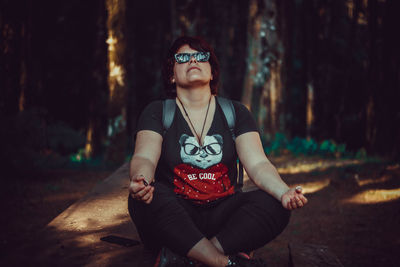 Portrait of young man sitting on land