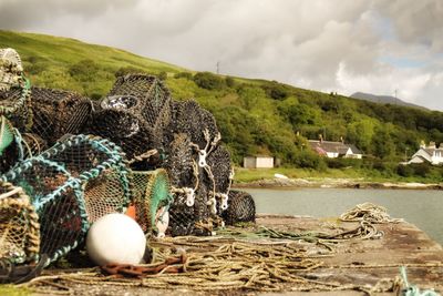 View of fishing net at harbor against sky