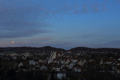 High angle shot of townscape against sky at sunset