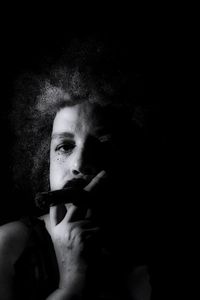 Portrait of young man smoking cigarette