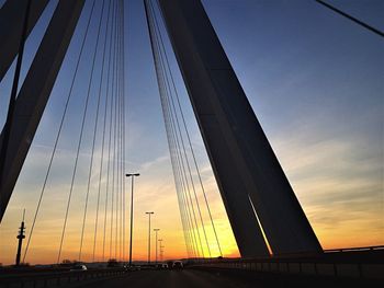 Suspension bridge against sky during sunset