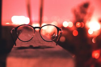 Close-up of eyeglasses on railing