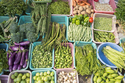 High angle view of vegetables in plastic containers at market for sale