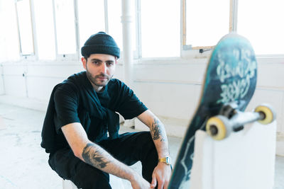 Portrait of man sitting on sport ramp