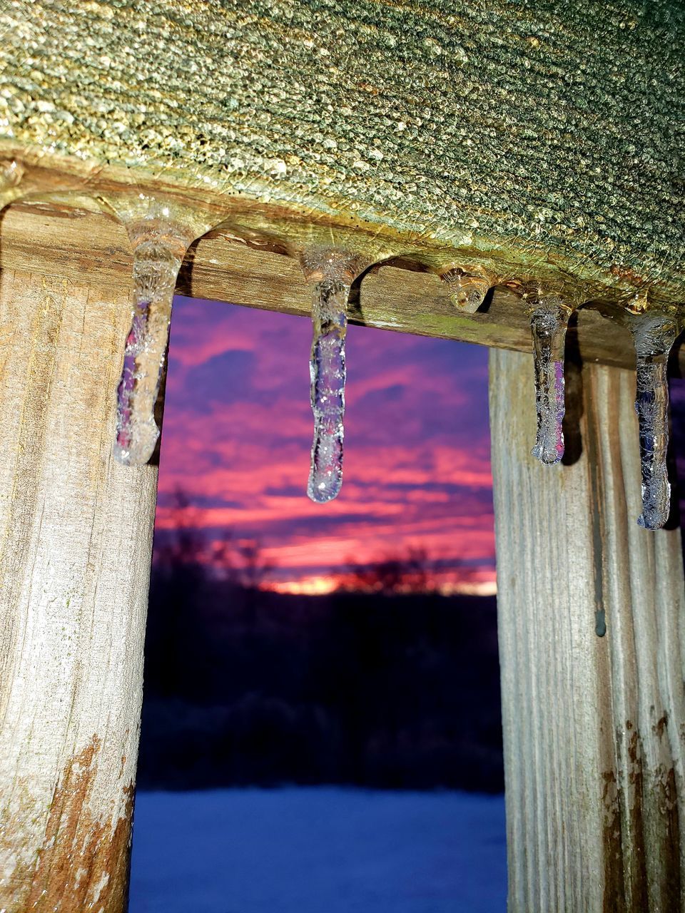 LOW ANGLE VIEW OF ICICLES AGAINST SKY