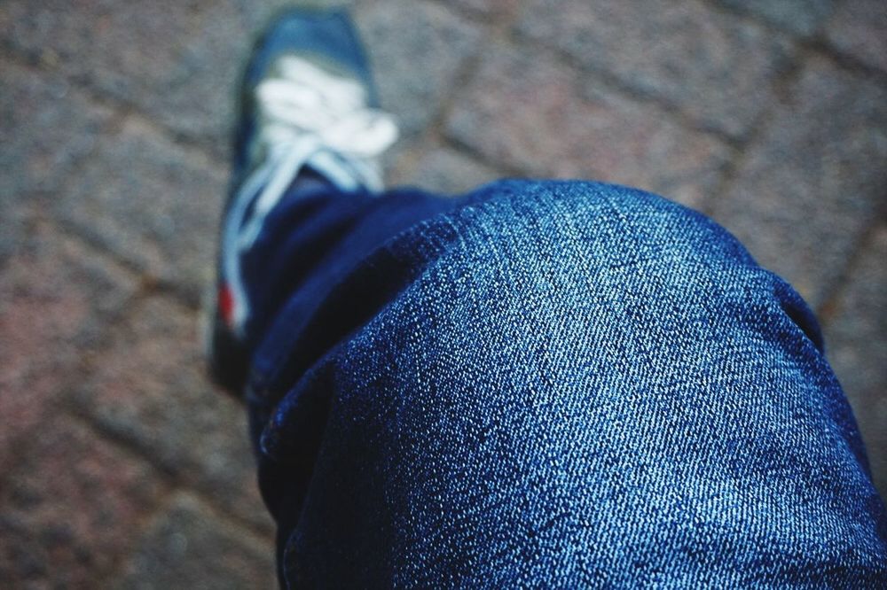 low section, person, blue, close-up, jeans, shoe, indoors, part of, personal perspective, focus on foreground, textile, unrecognizable person, footwear, fashion, fabric, lifestyles, men