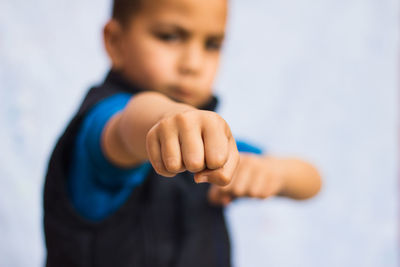 Close-up of boy clenching fist