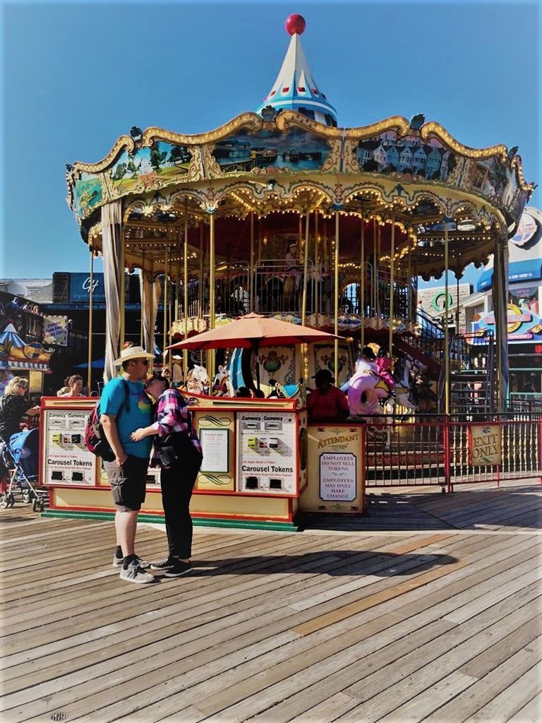 REAR VIEW OF PEOPLE AT AMUSEMENT PARK RIDE