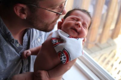 Father and son holding baby