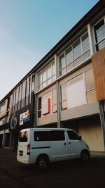 Car on street against buildings in city