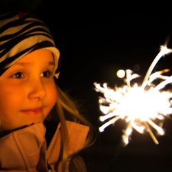 Portrait of girl in illuminated park at night