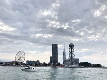 Towers by river in city