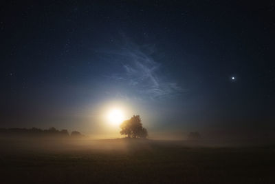 Low angle view of silhouette mountain against sky at night