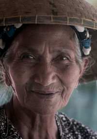 Close-up portrait of senior woman with wicker basket