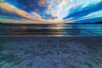 Scenic view of beach against sky during sunset