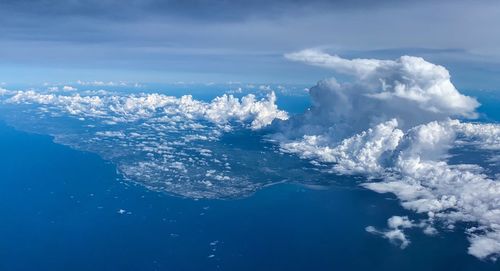 Aerial view of sea against cloudy sky