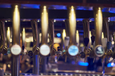 Close-up of beer taps at bar