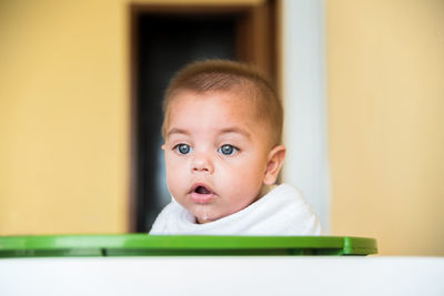 Close-up of baby boy in container at home