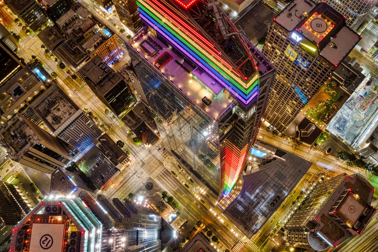 HIGH ANGLE VIEW OF ILLUMINATED BUILDINGS IN CITY