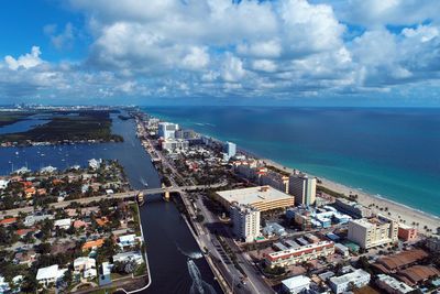 High angle view of buildings by sea against sky