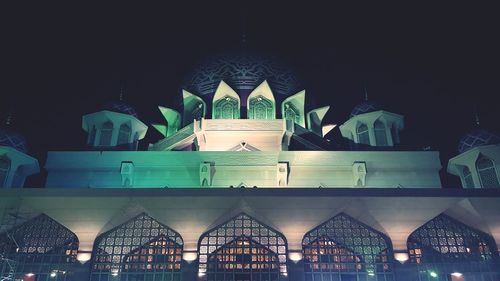 Digital composite image of illuminated building at night