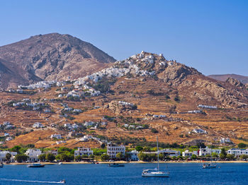 Scenic view of sea and mountains against clear sky