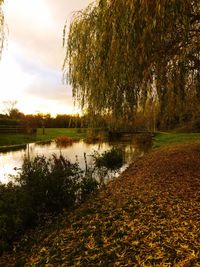 Scenic view of lake against sky at sunset