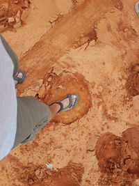 Low section of man standing on rock