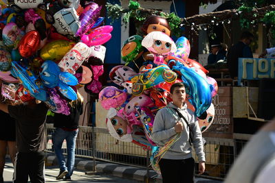 People standing in multi colored balloons