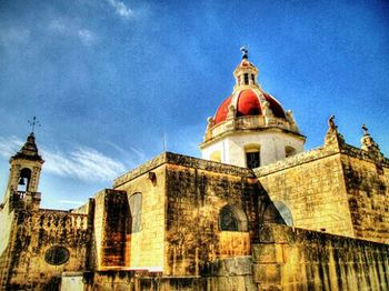 Low angle view of church against blue sky