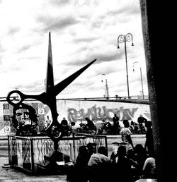 Group of people in city against sky