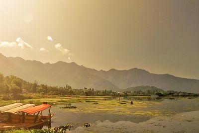 Dal lake with shikara and mountains in backdrop