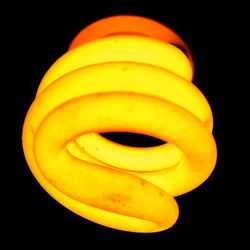 Close-up of yellow light over black background