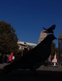 Statue against clear blue sky