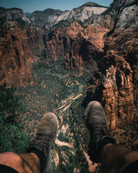 Low section of man relaxing on rock