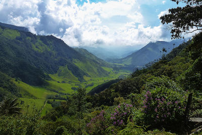 Scenic view of mountains against cloudy sky