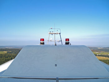 Lifeguard hut on land against clear blue sky