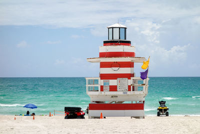 Lifeguard hut on beach against sky